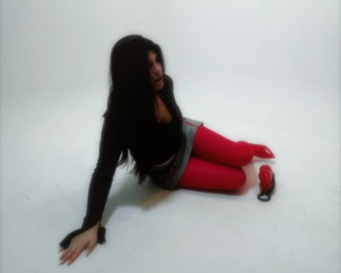 Person wearing red stockings and a black top and Pomegranate minion a white background